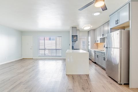 a renovated kitchen with stainless steel appliances and white cabinets