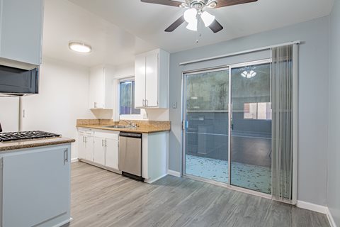 A modern kitchen with a fan on the ceiling.