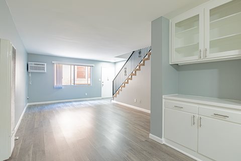 A room with a staircase and cabinets.