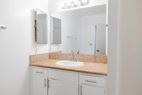 A bathroom with a sink and mirror.