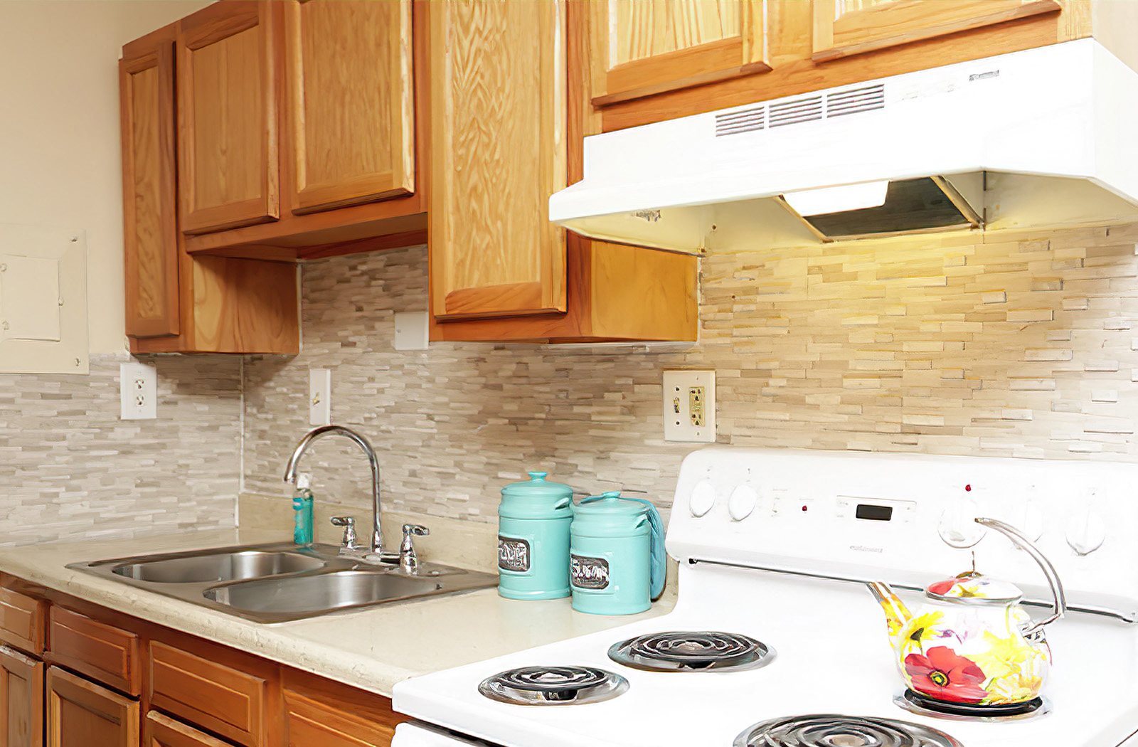 a kitchen with wood cabinets and white appliances