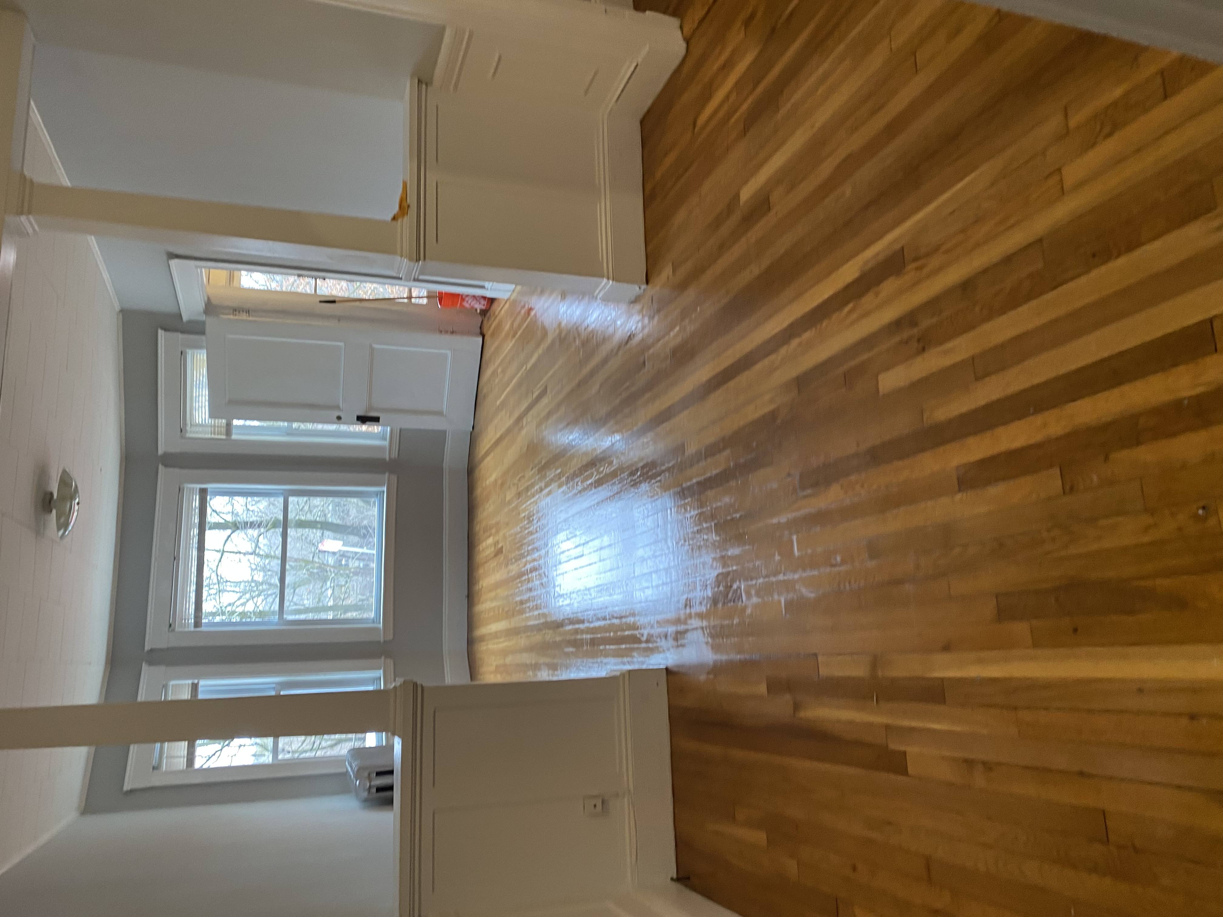 A wooden staircase leads up to a second floor.