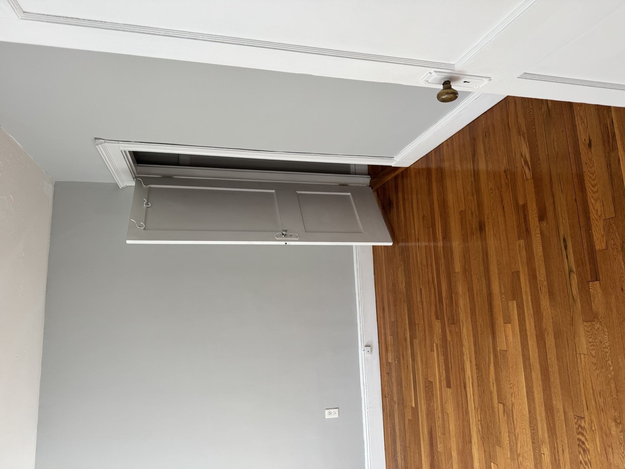 A wall with a vent in the middle of it.,A wall with a vent in the middle of it.