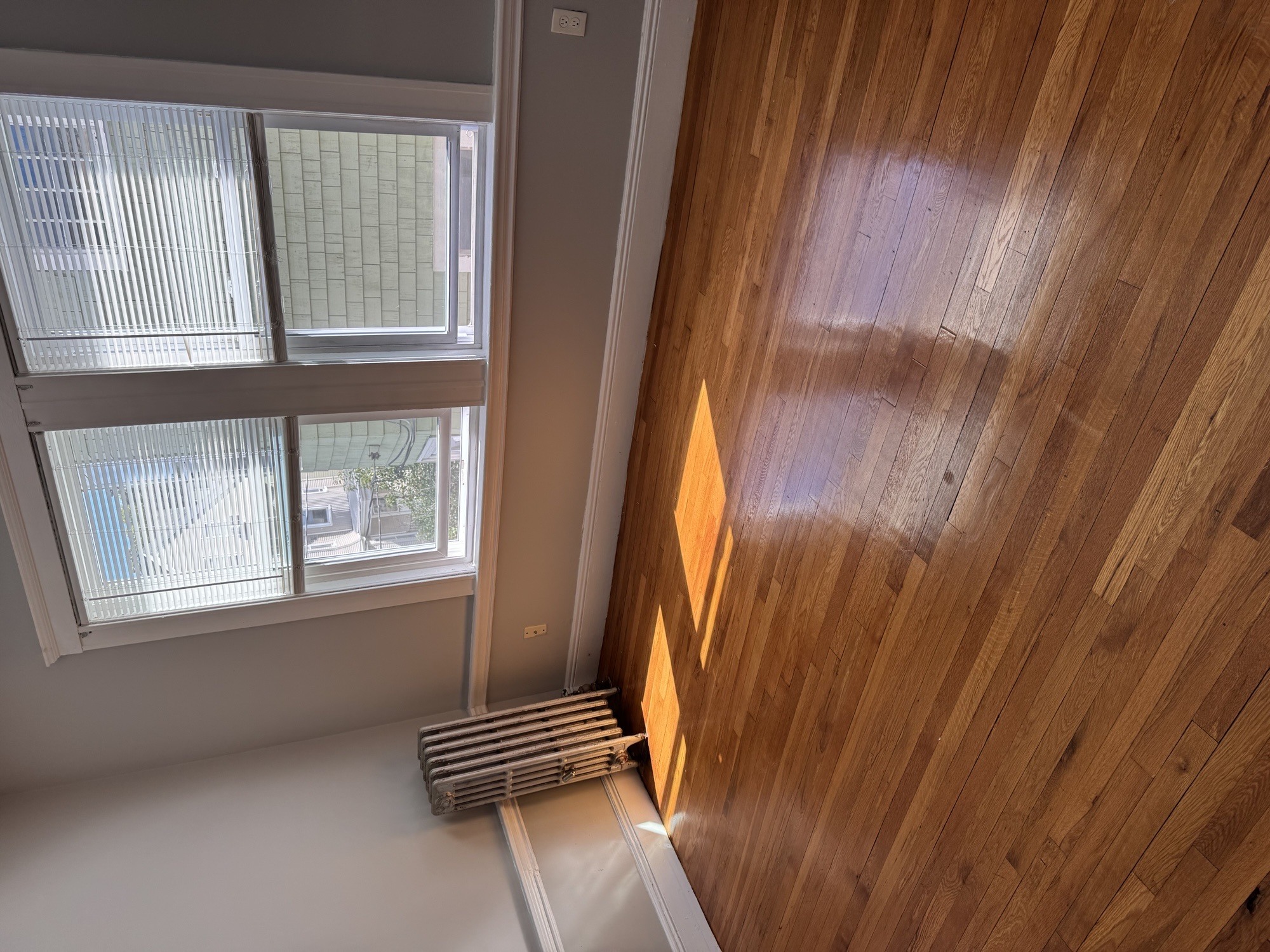 A room with a window and a wooden ceiling.