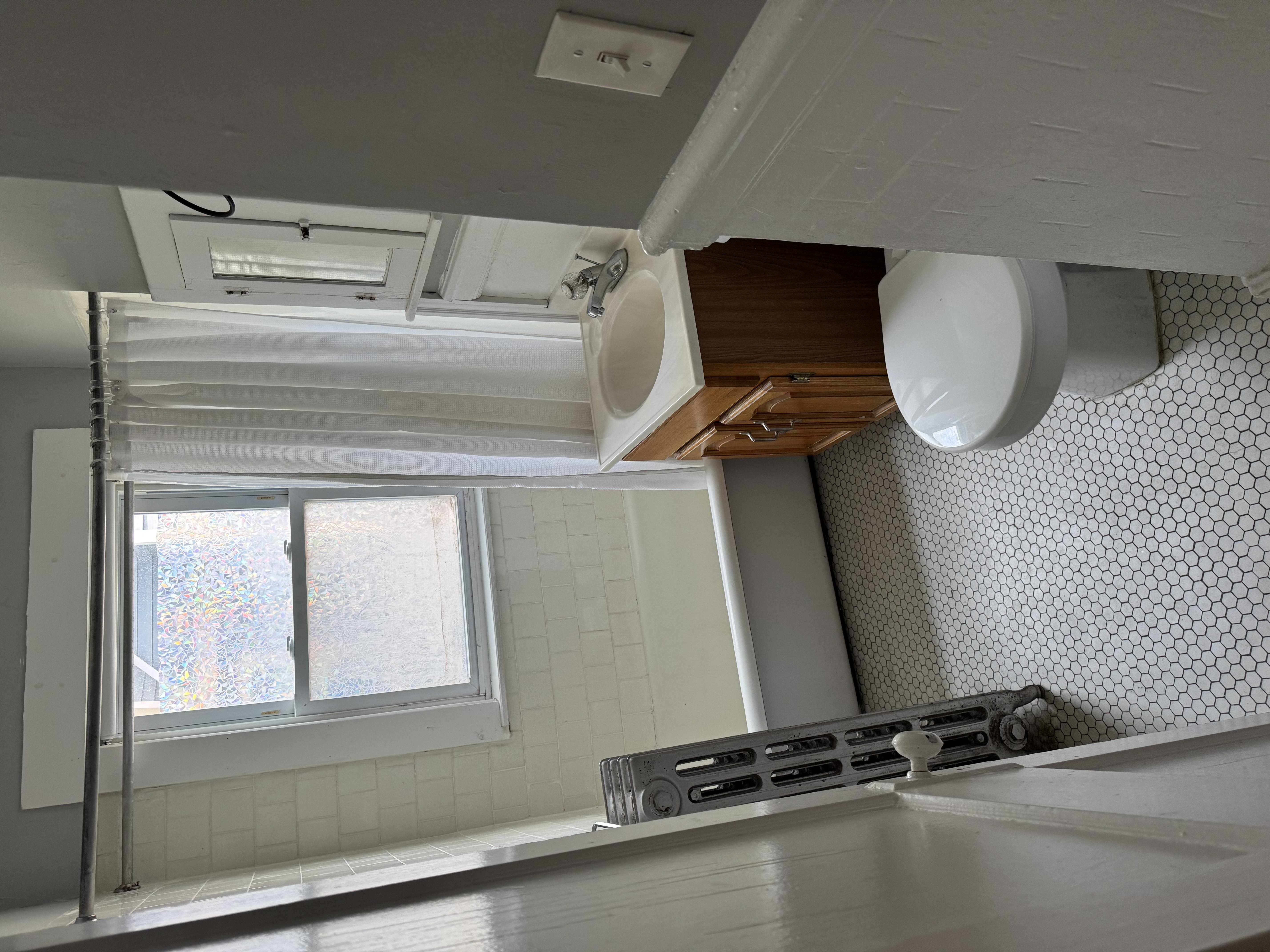 A kitchen with a window and a sink.