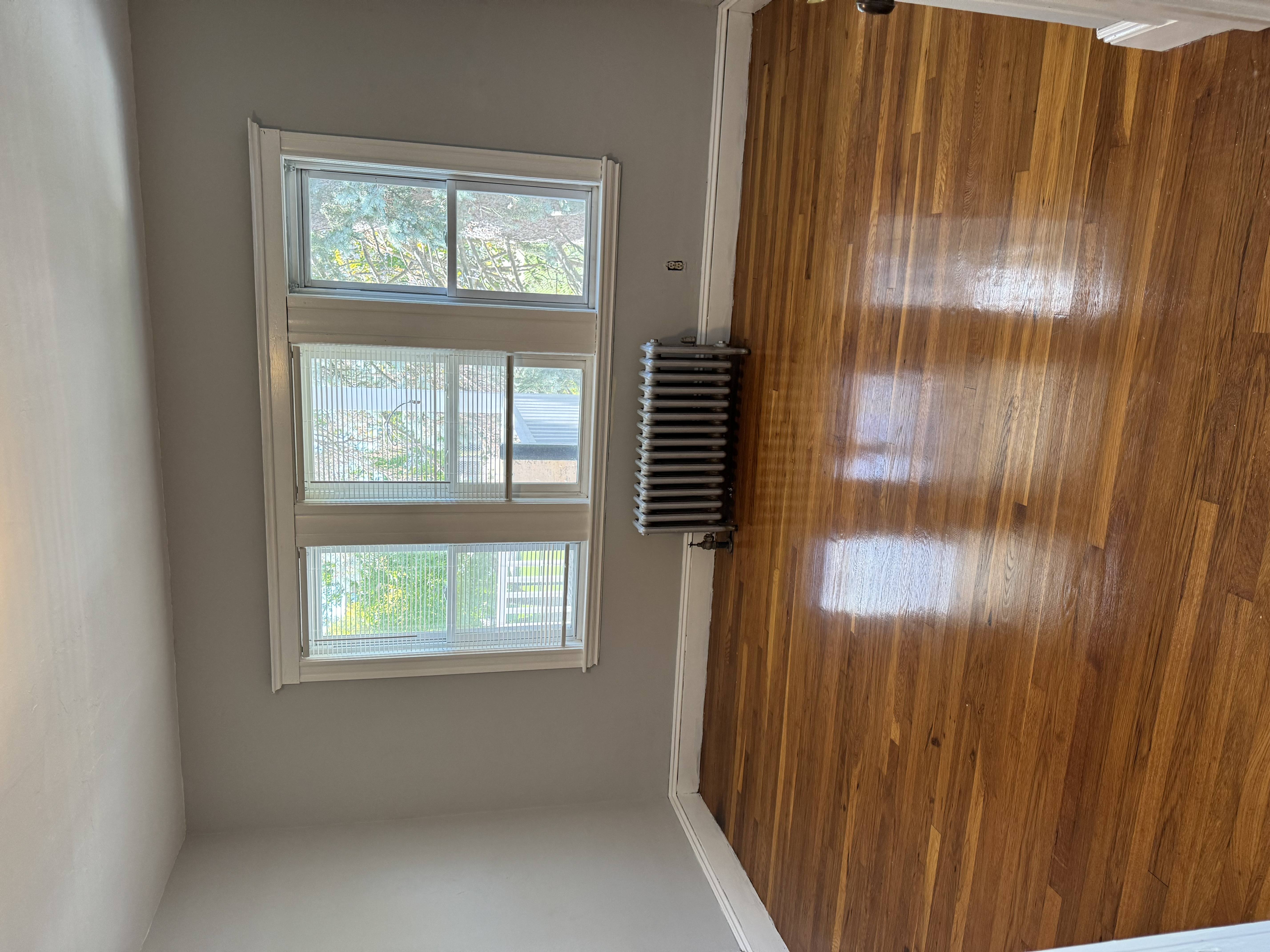 A window with a white frame is on the wall.