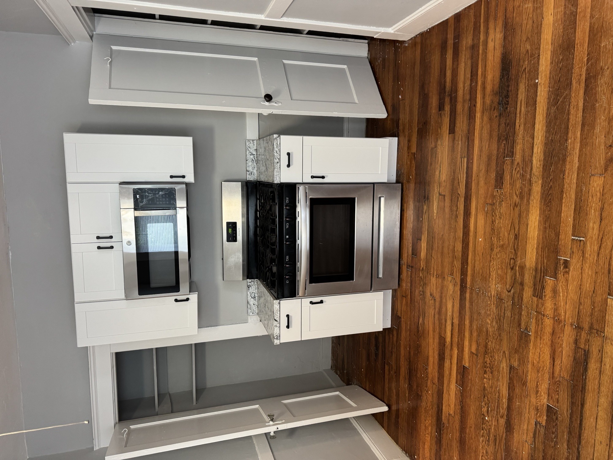 A kitchen with two microwaves and a stove top oven.