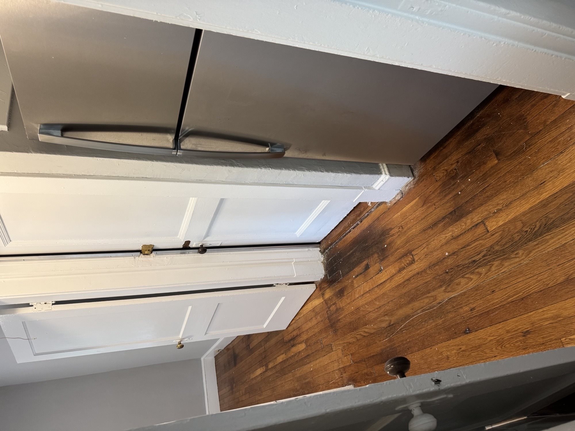 A white ceiling with a black pipe running across it.,A white ceiling with a black pipe running across it.