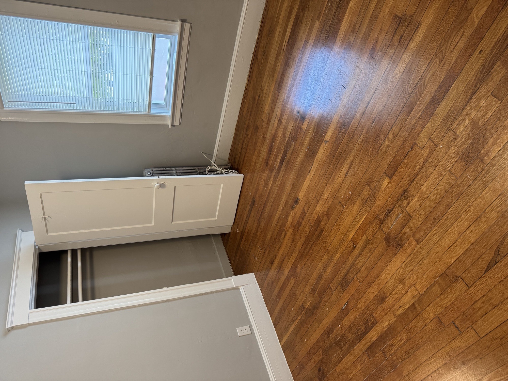A wooden ceiling with a window and a white cabinet below it.