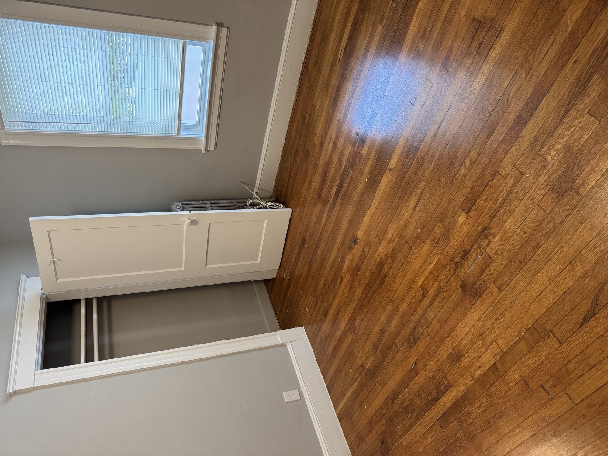 A wooden ceiling with a window and a white cabinet below it.