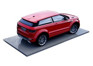 A red car is shown from the rear view on a grey platform.