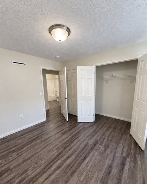 A room with a white door and a light on the ceiling.