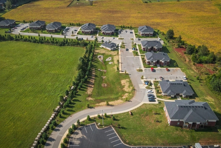 A residential area with houses and a parking lot.
