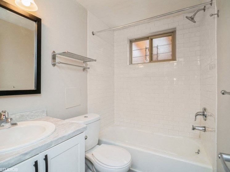 Sparkling White Bathroom with Updated Cabinets at 1443 Elizabeth