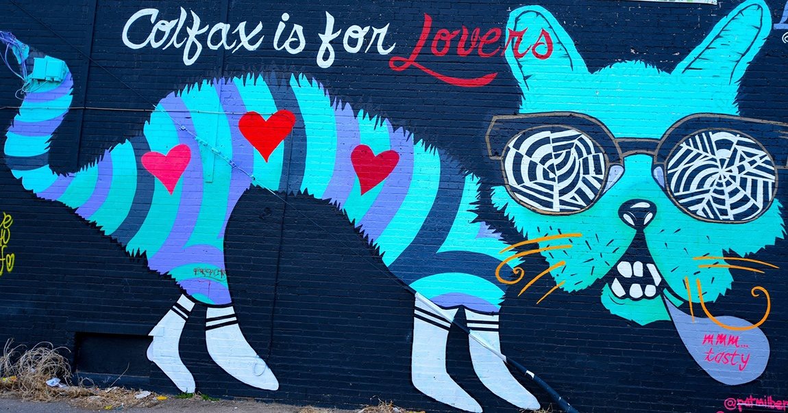 Colorful street art with a playful cat and bold “Colfax is for Lovers” lettering—quirky charm that defines the neighborhood’s personality at 1444 Saint Paul St in Denver, CO