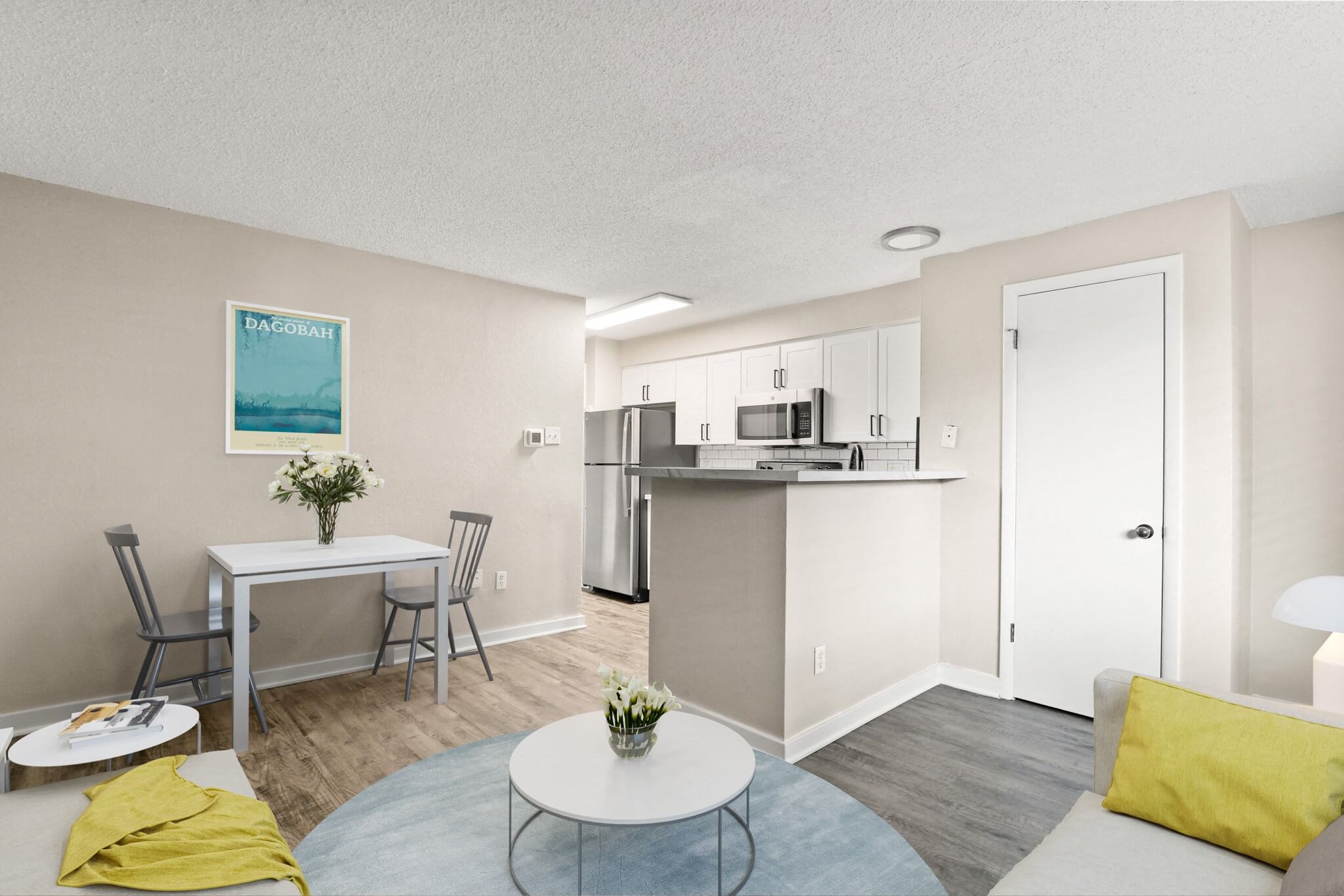 Open-concept kitchen and dining space with stainless steel appliances, bar seating, and cozy living area at 1443 Elizabeth in Denver, CO