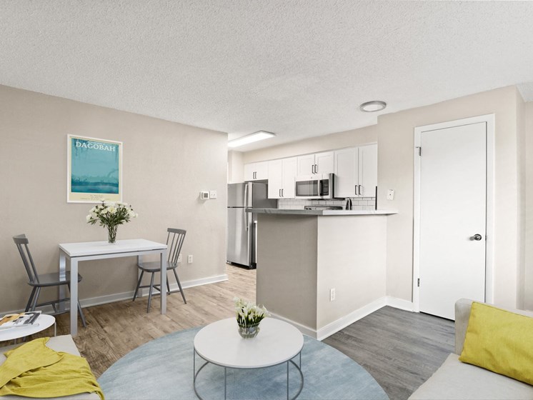 Open-concept kitchen and dining space with stainless steel appliances, bar seating, and cozy living area at 1443 Elizabeth in Denver, CO