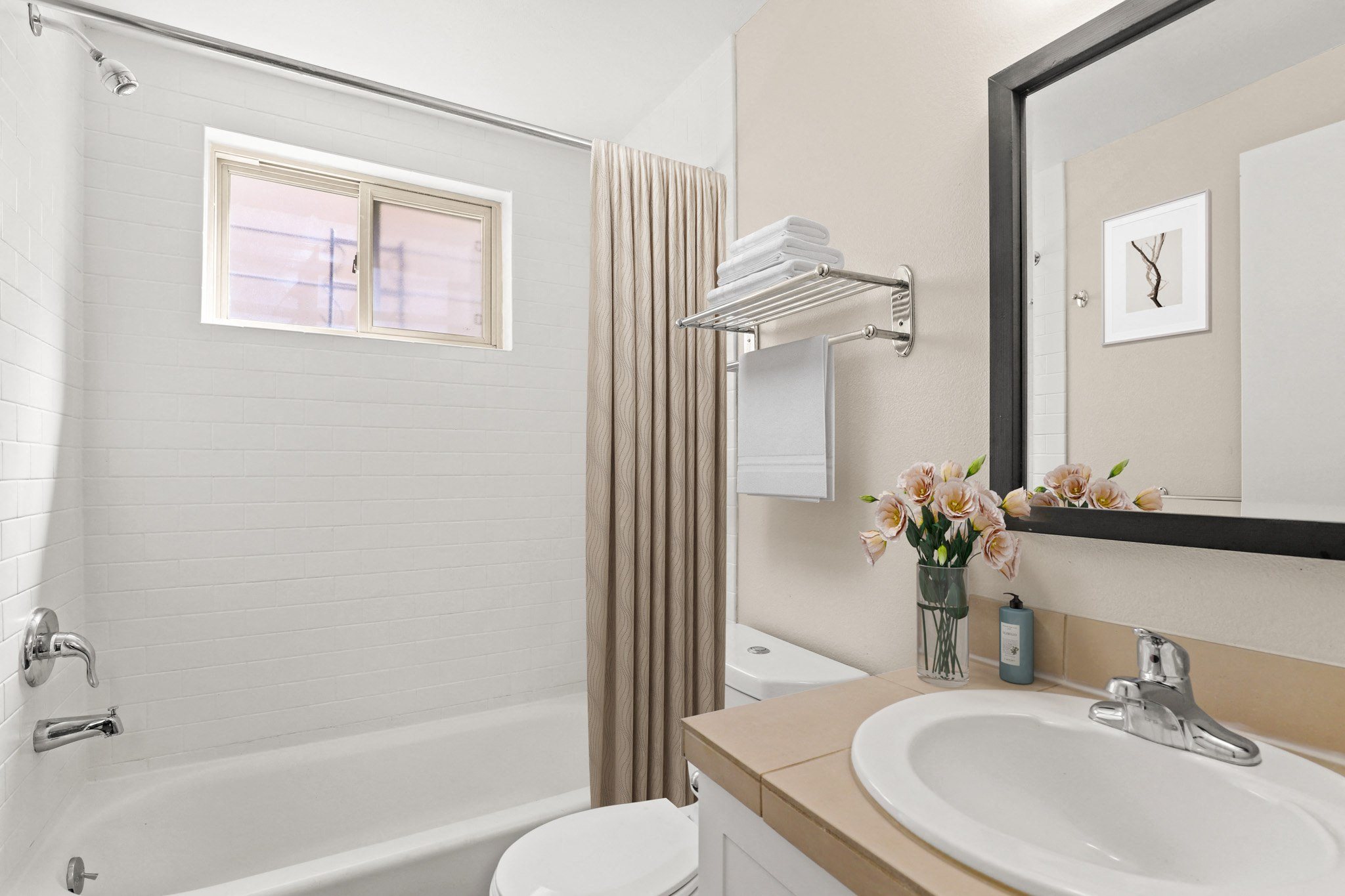 Modern bathroom with a white tile shower, built-in tub, single vanity, and neutral-toned finishes at 1443 Elizabeth in Denver, CO
