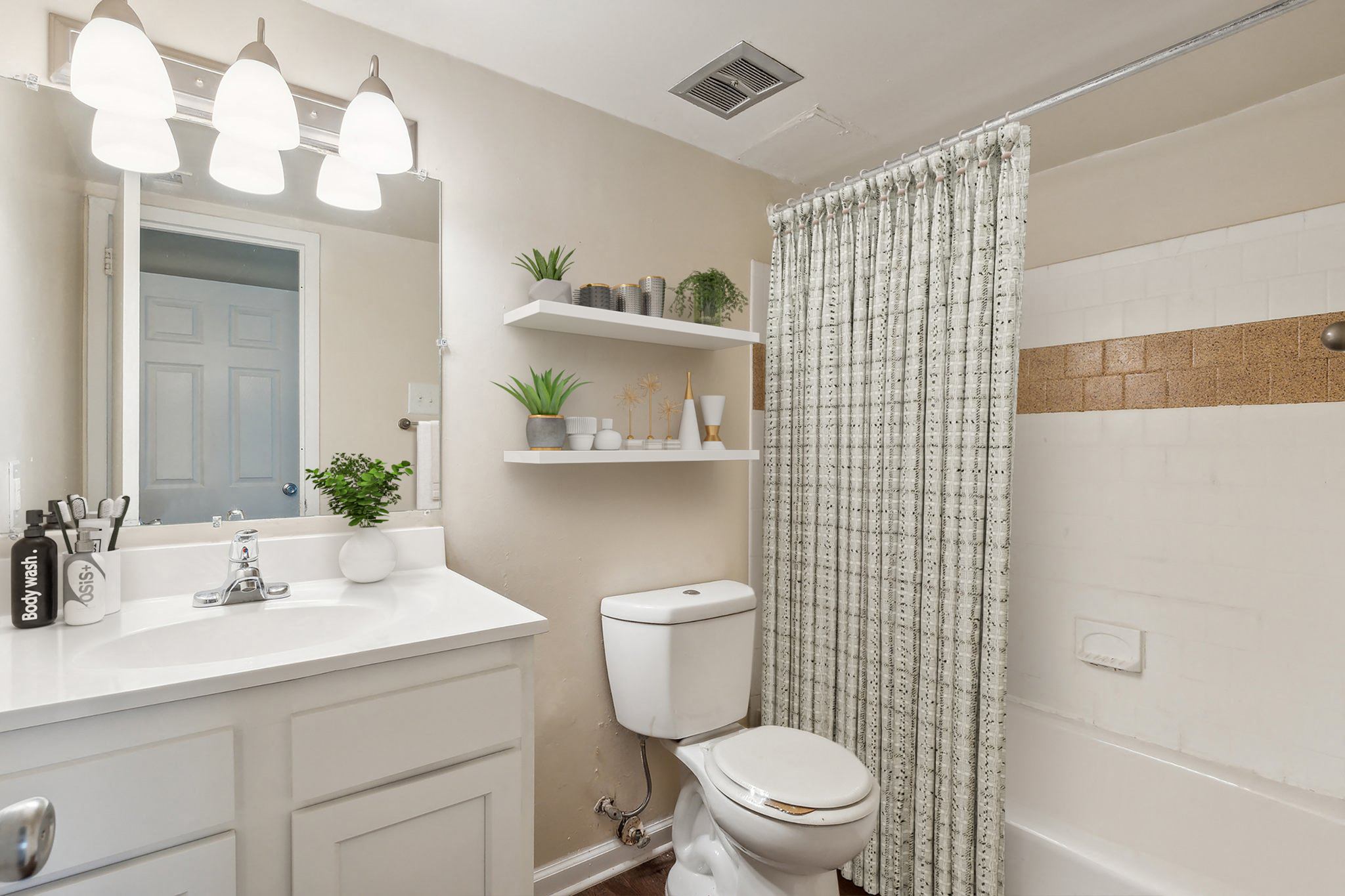 a bathroom with a shower curtain and a toilet and a sink