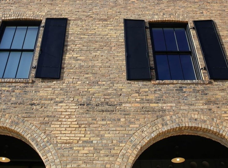 Window Panels with Black Shutters on Brick Exterior at 700 Central Apartments, Minneapolis, Minnesota