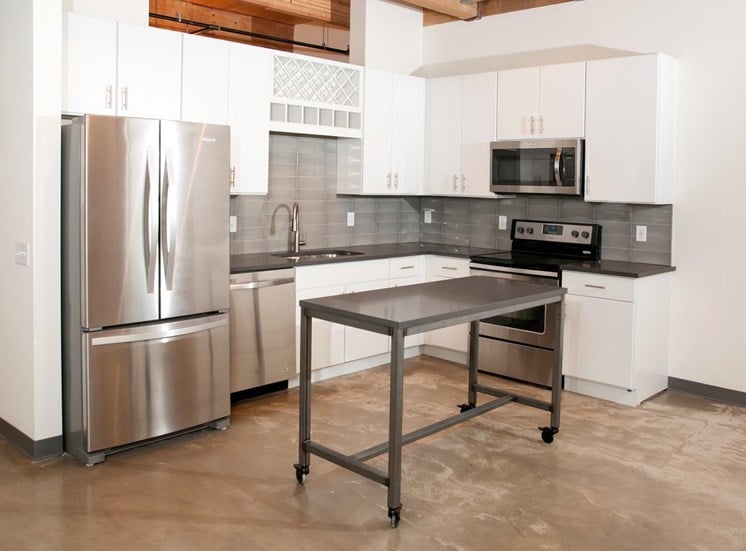 Kitchen with White Cabinetry, Stainless Steal Appliances and Movable Island at 700 Central Apartments, MN, 55414