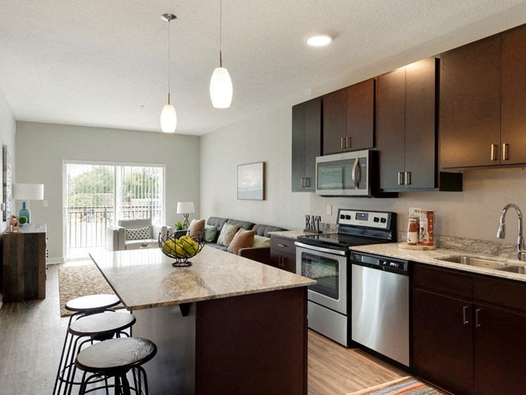 Kitchen and living w/balcony at The Liberty Townhomes in Golden Valley, 55427