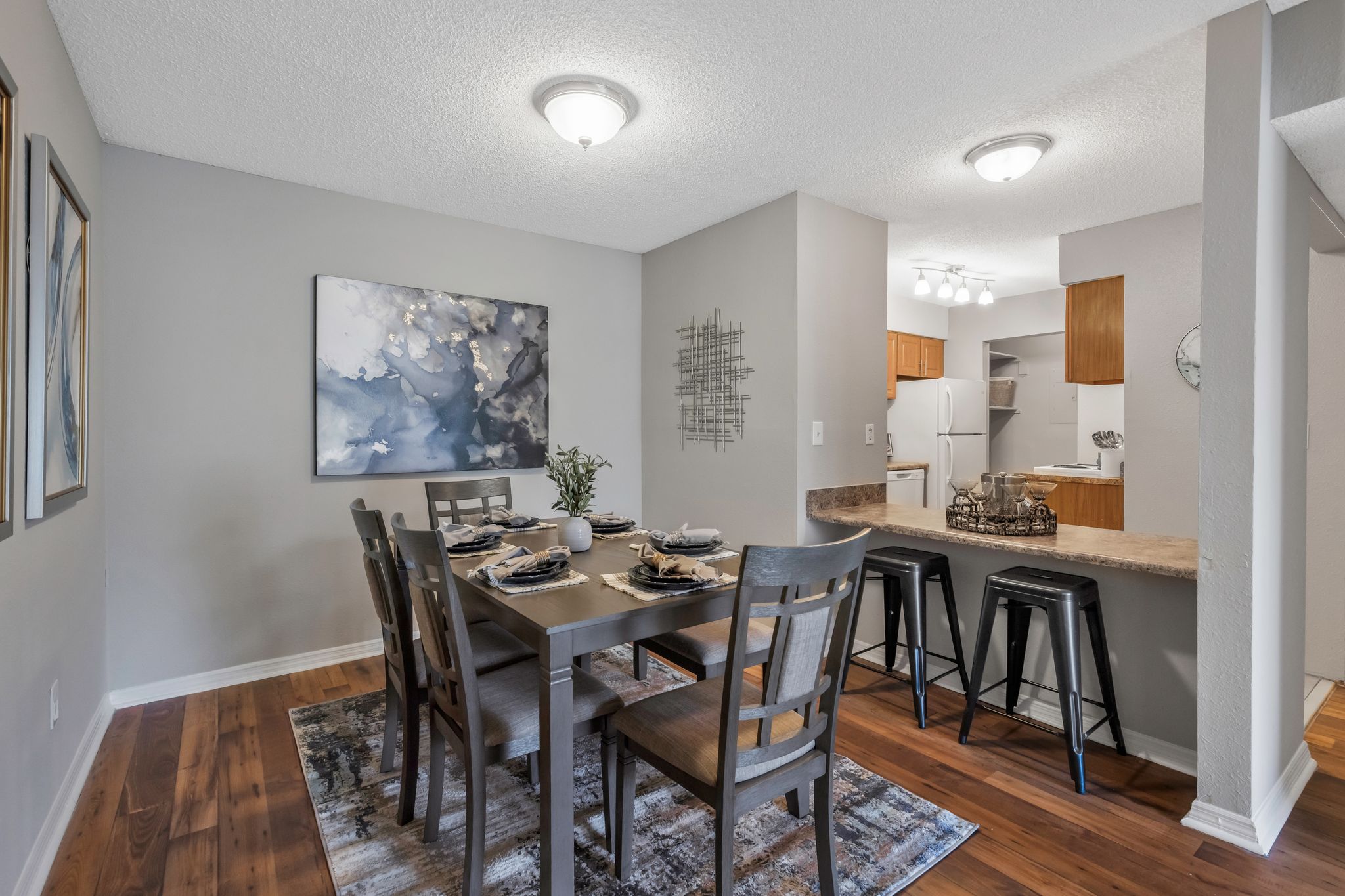 A dining room with a table set for six.