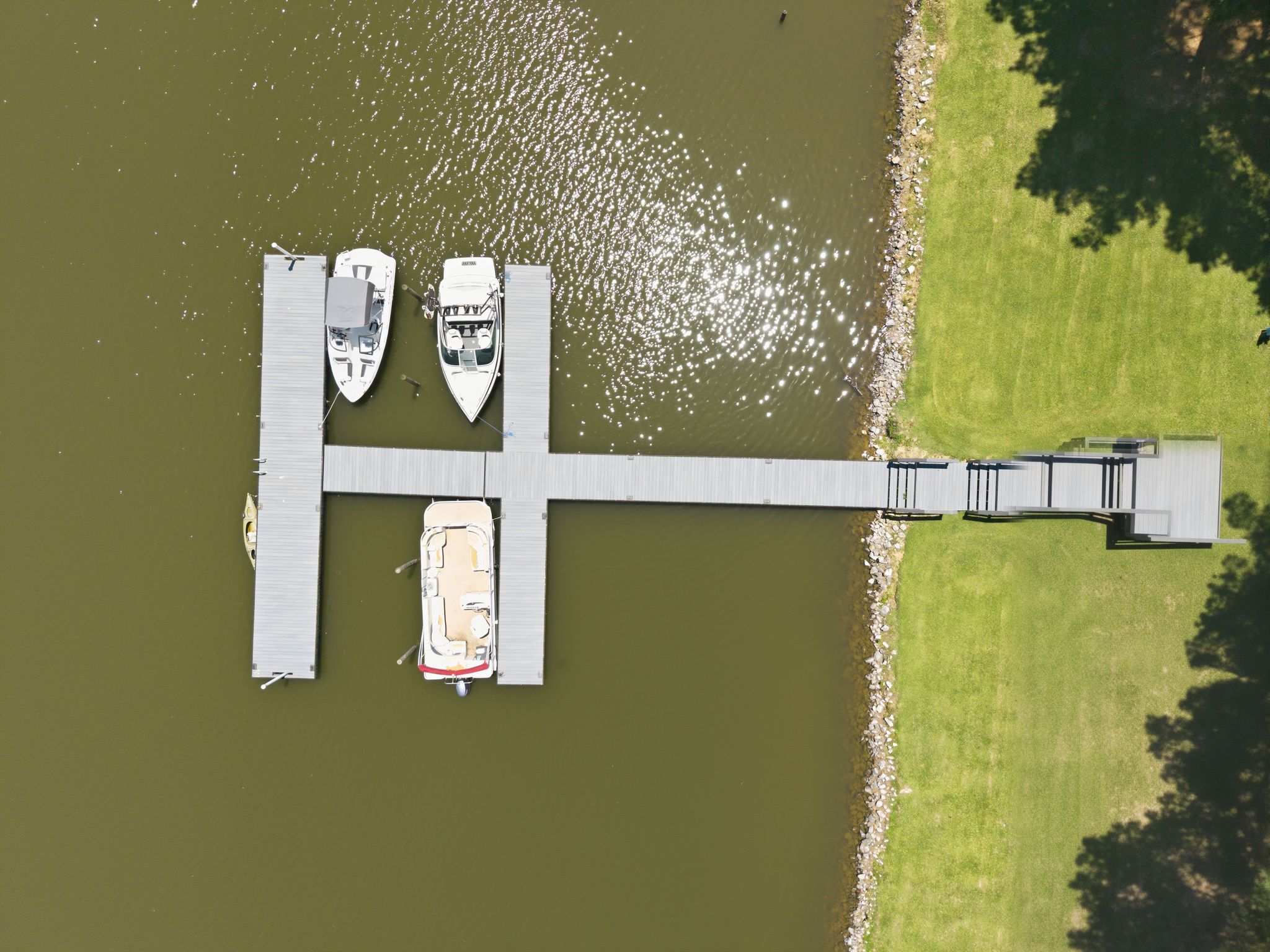 Two boats are docked at a pier.