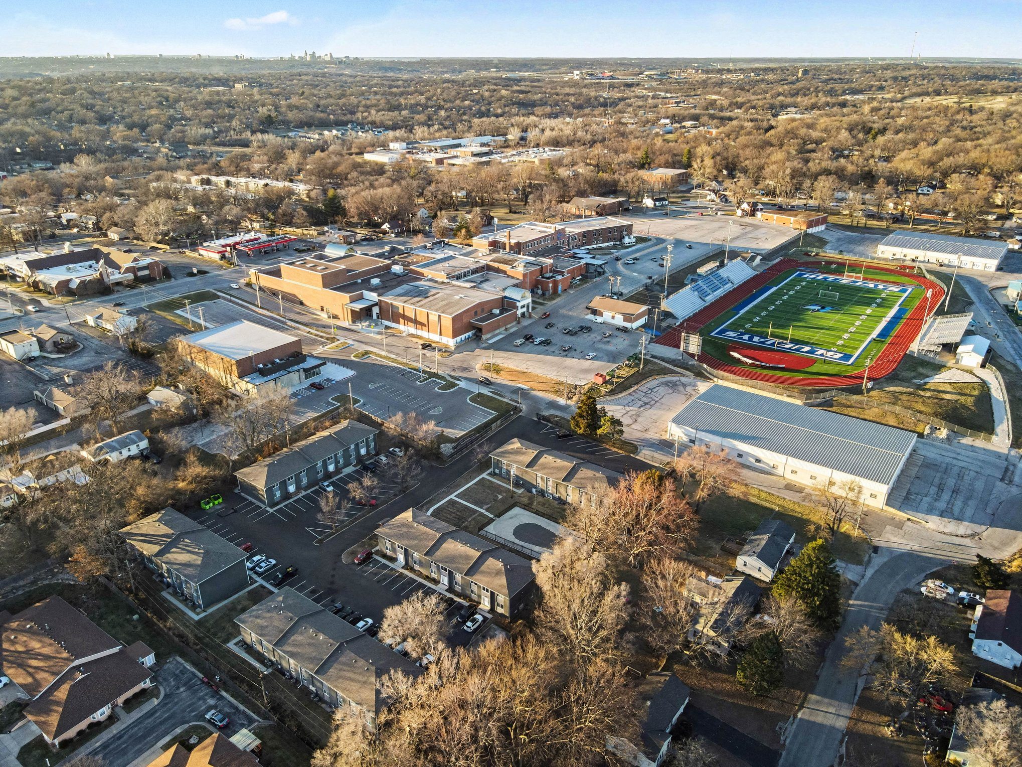 An aerial view of a school with a football field.