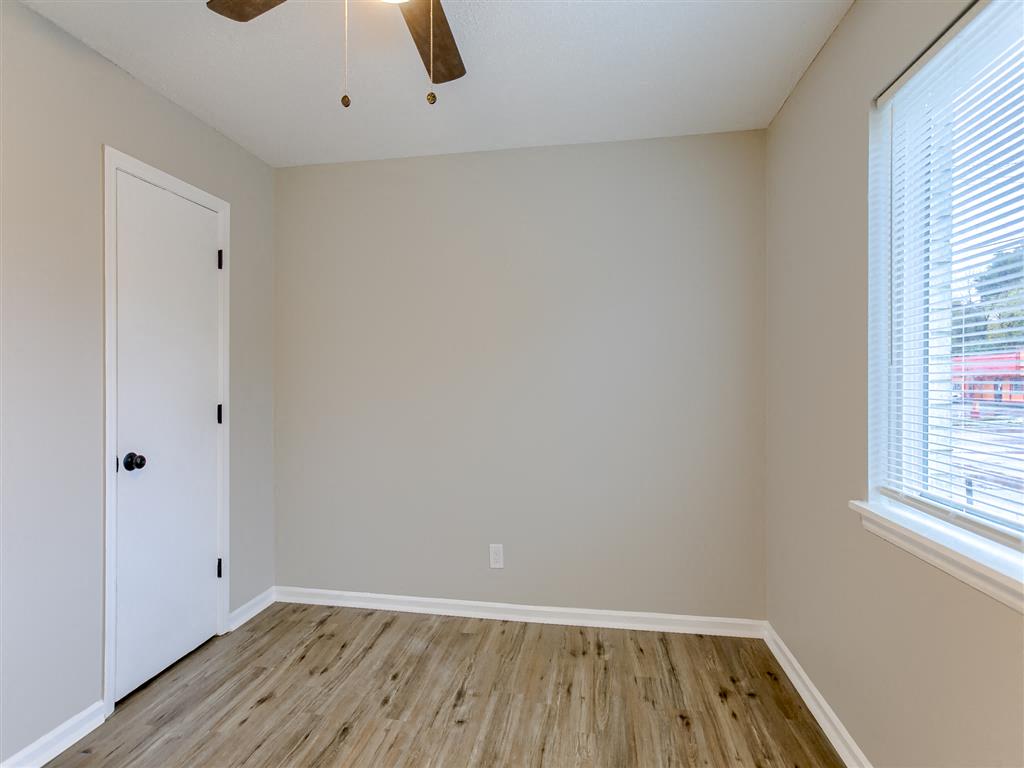 an empty room with a window and a door