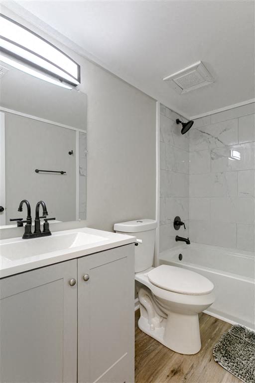 a white bathroom with a toilet and a sink