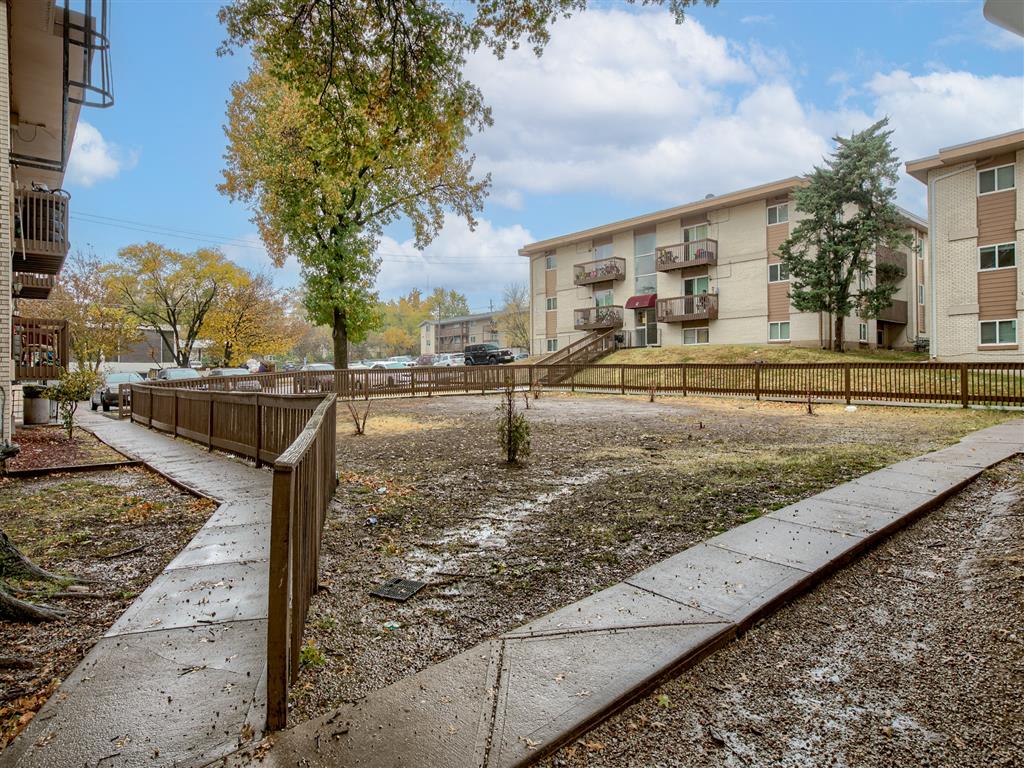 an empty yard in front of an apartment building