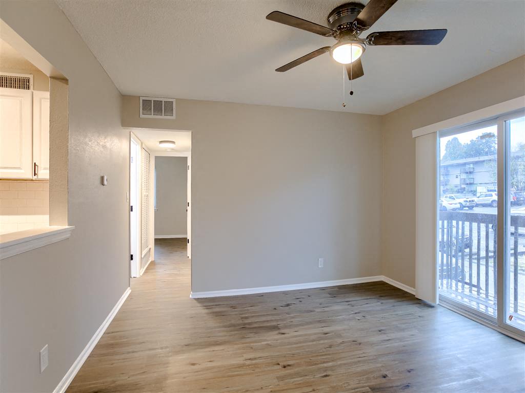 a living room with a ceiling fan and a window