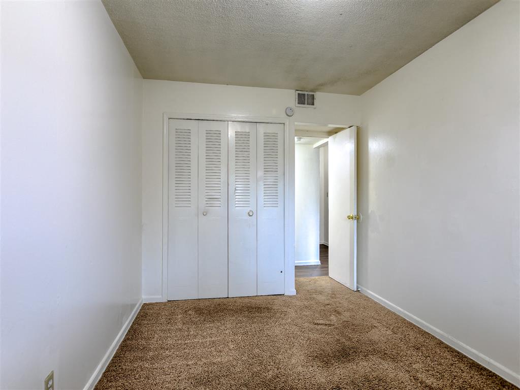a bedroom with a carpet
