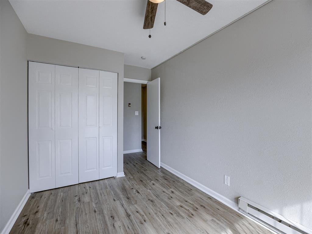 a bedroom with a ceiling fan