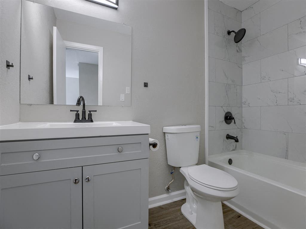 a bathroom with a sink, toilet and a bath tub