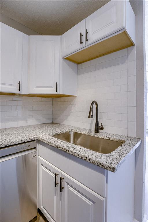 a kitchen with white cabinets and white counter tops