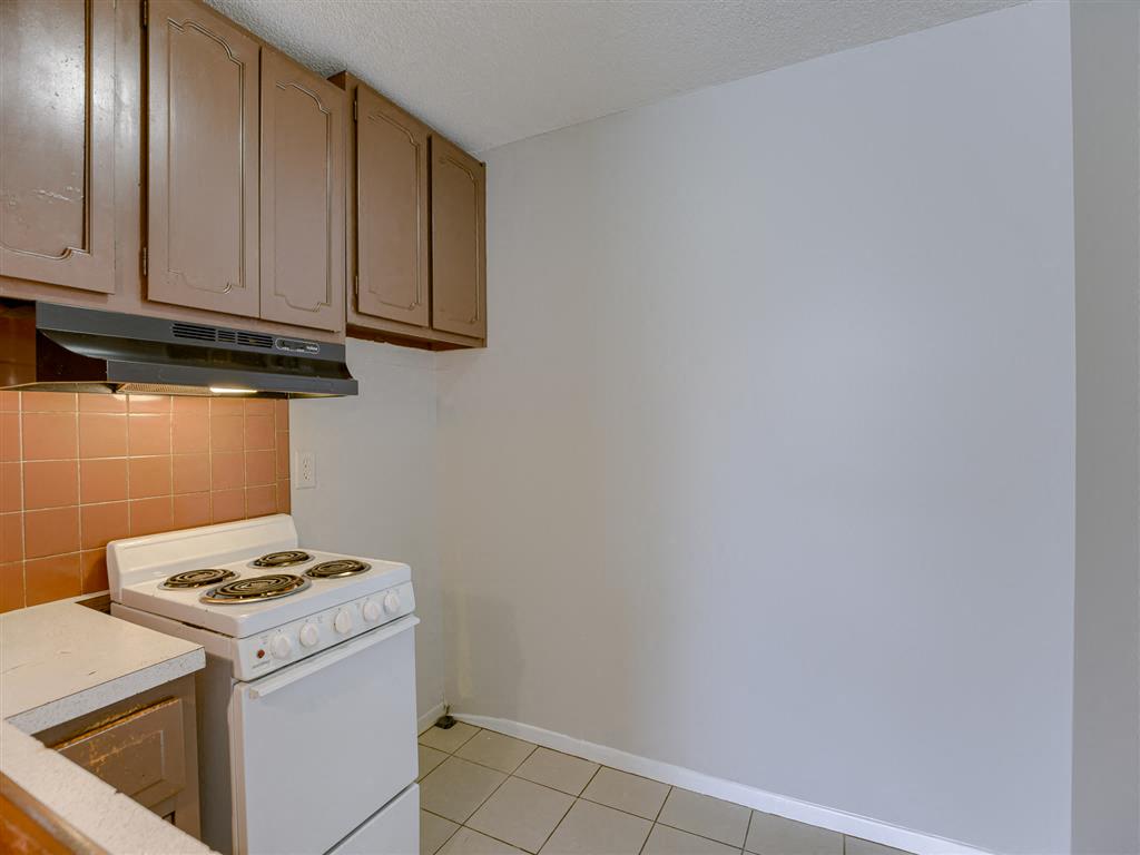 a kitchen with white appliances and wooden cabinets