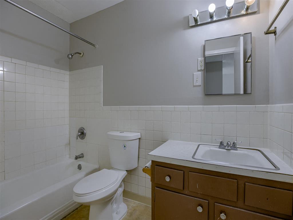 a bathroom with a sink toilet and a bath tub