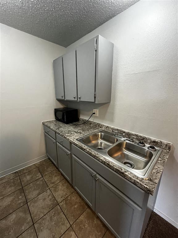 a kitchen with a stainless steel sink and counters