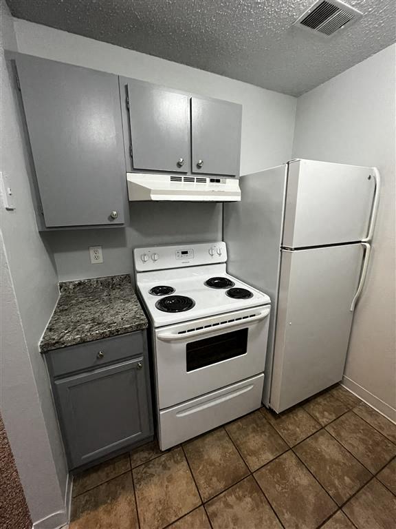 a kitchen with a stove and a refrigerator