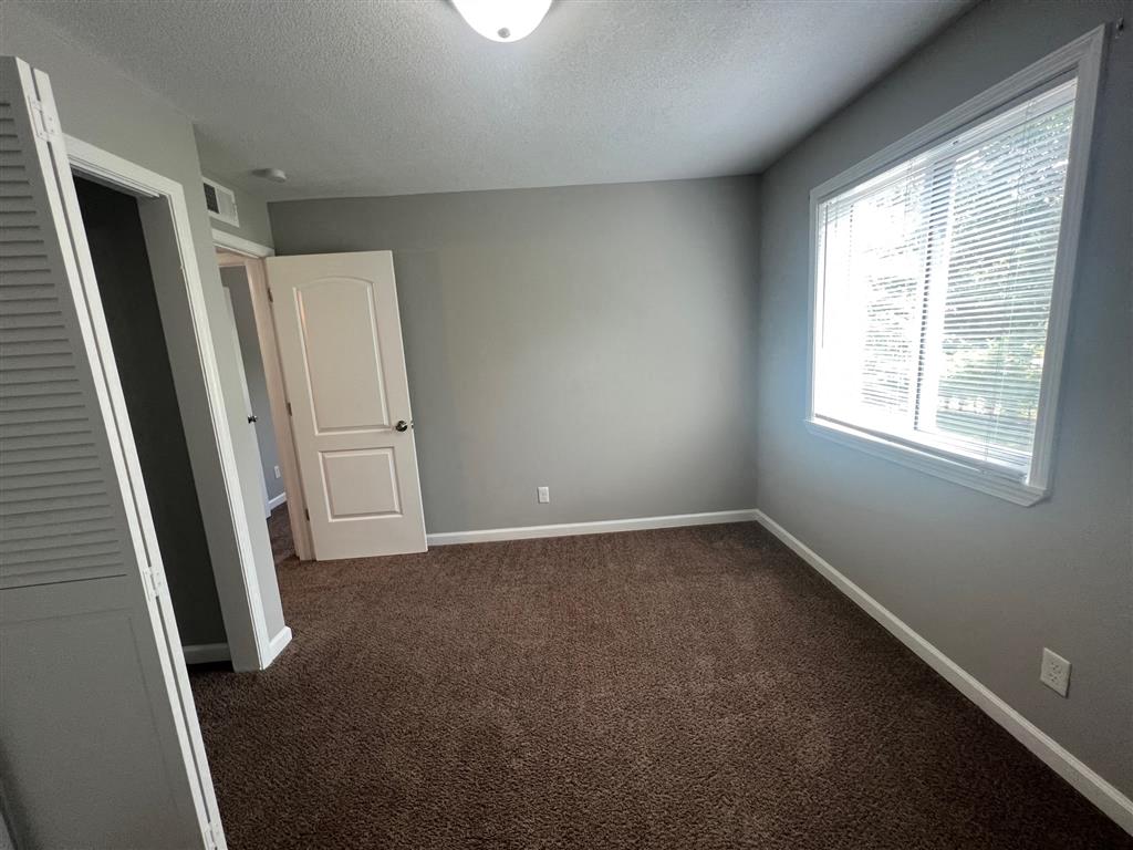 a empty room with a window and a door