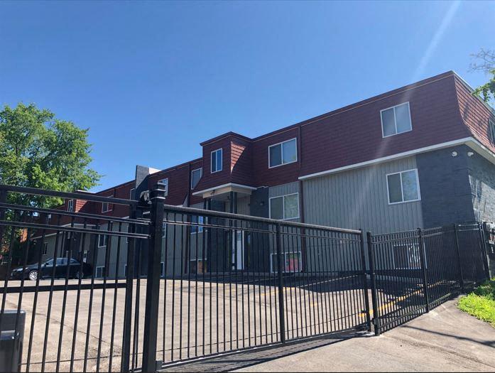 an apartment building with a gated fence in front of it