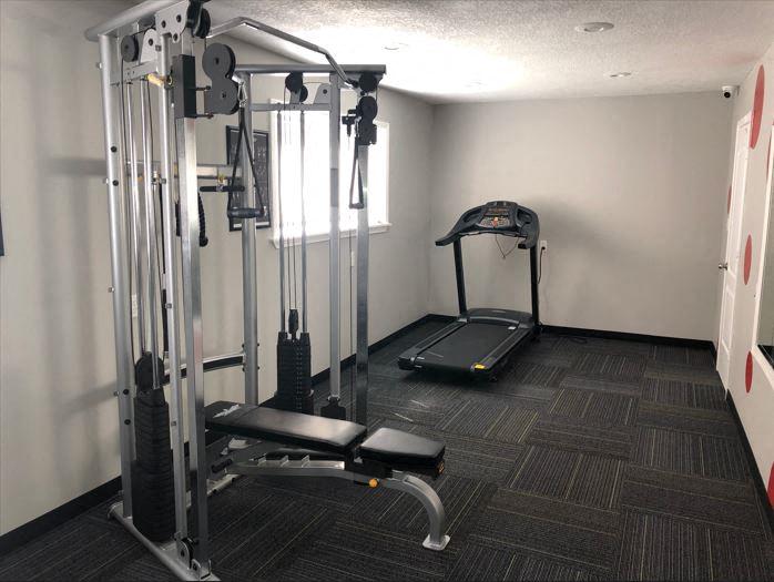 a gym with exercise equipment in a room