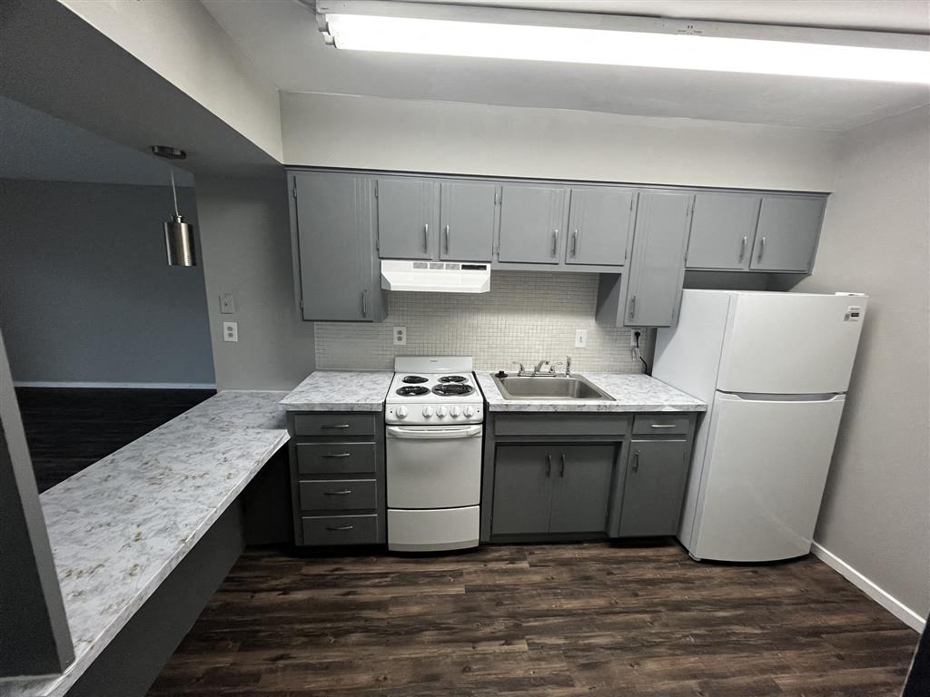 kitchen with white appliances and gray cabinets