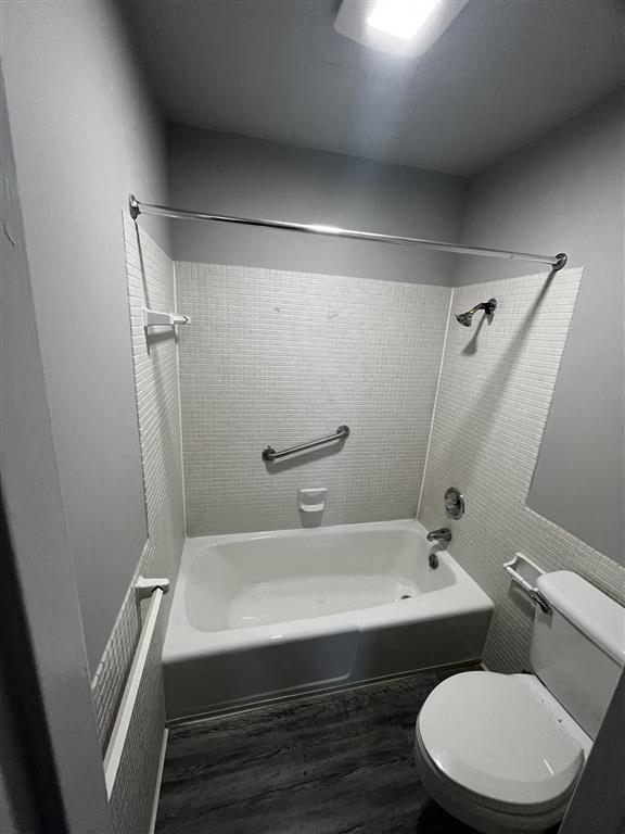 a bathroom with a toilet and a bath tub