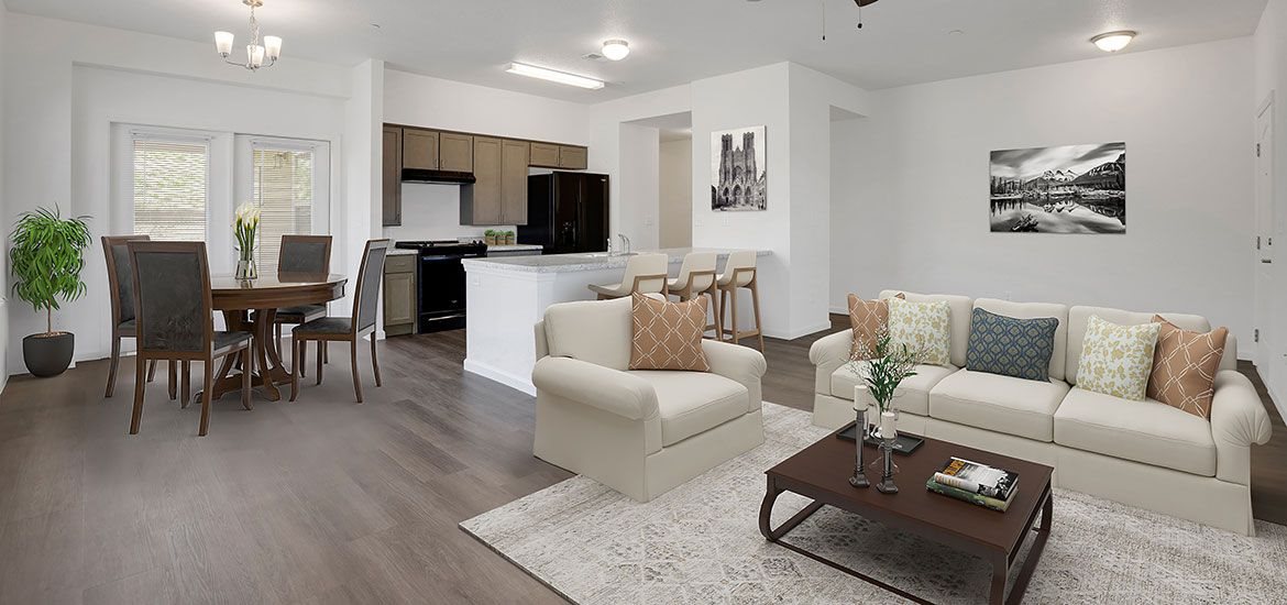 A living room with a couch, chairs, and a dining table.