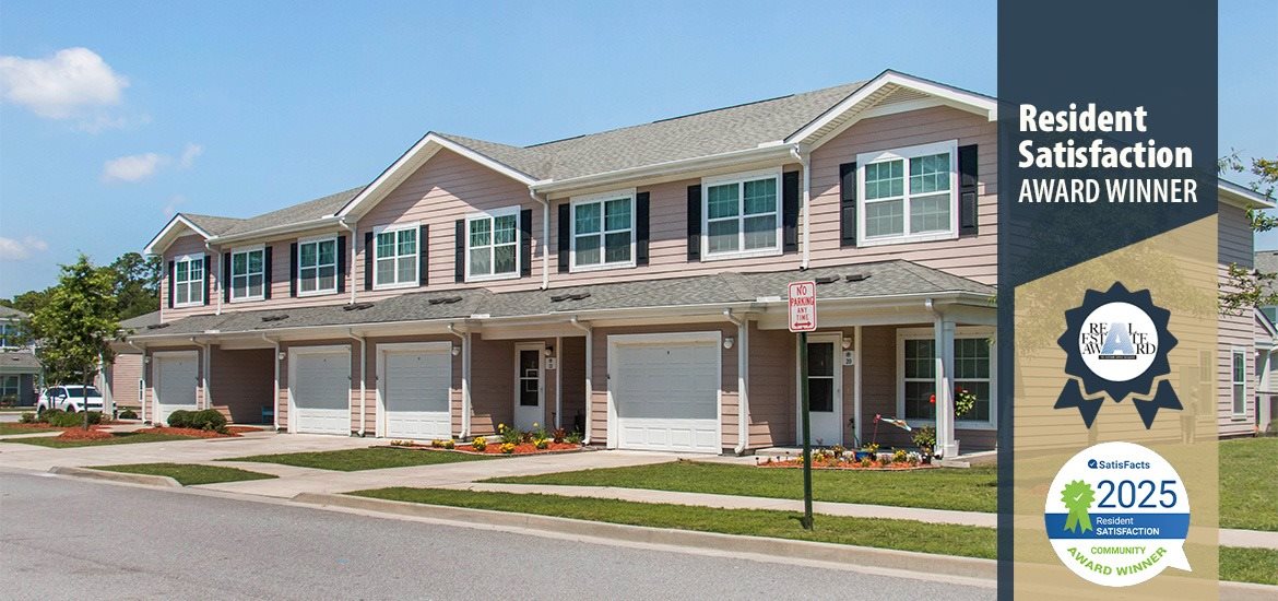 A residential building with a sign that says "Resident Satisfaction Award Winner".