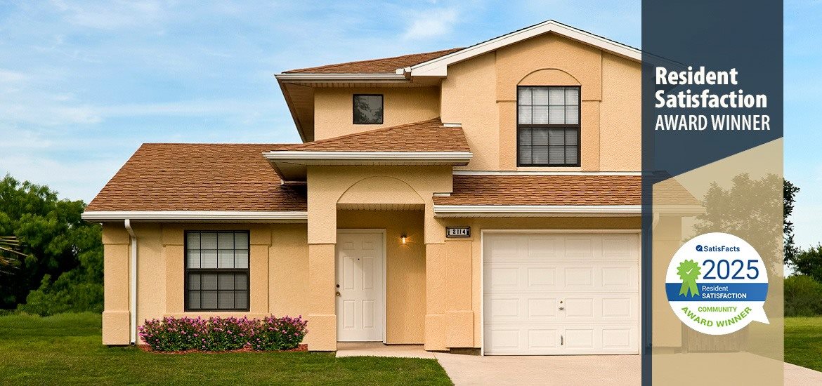 A residential house with a brown roof and a white garage door.