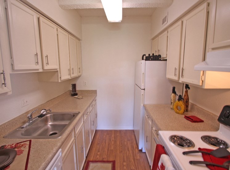 This is a photo of the kitchen in the 871 square foot 2 bedroom apartment at Harvard Square Apartments, in Dallas, TX.